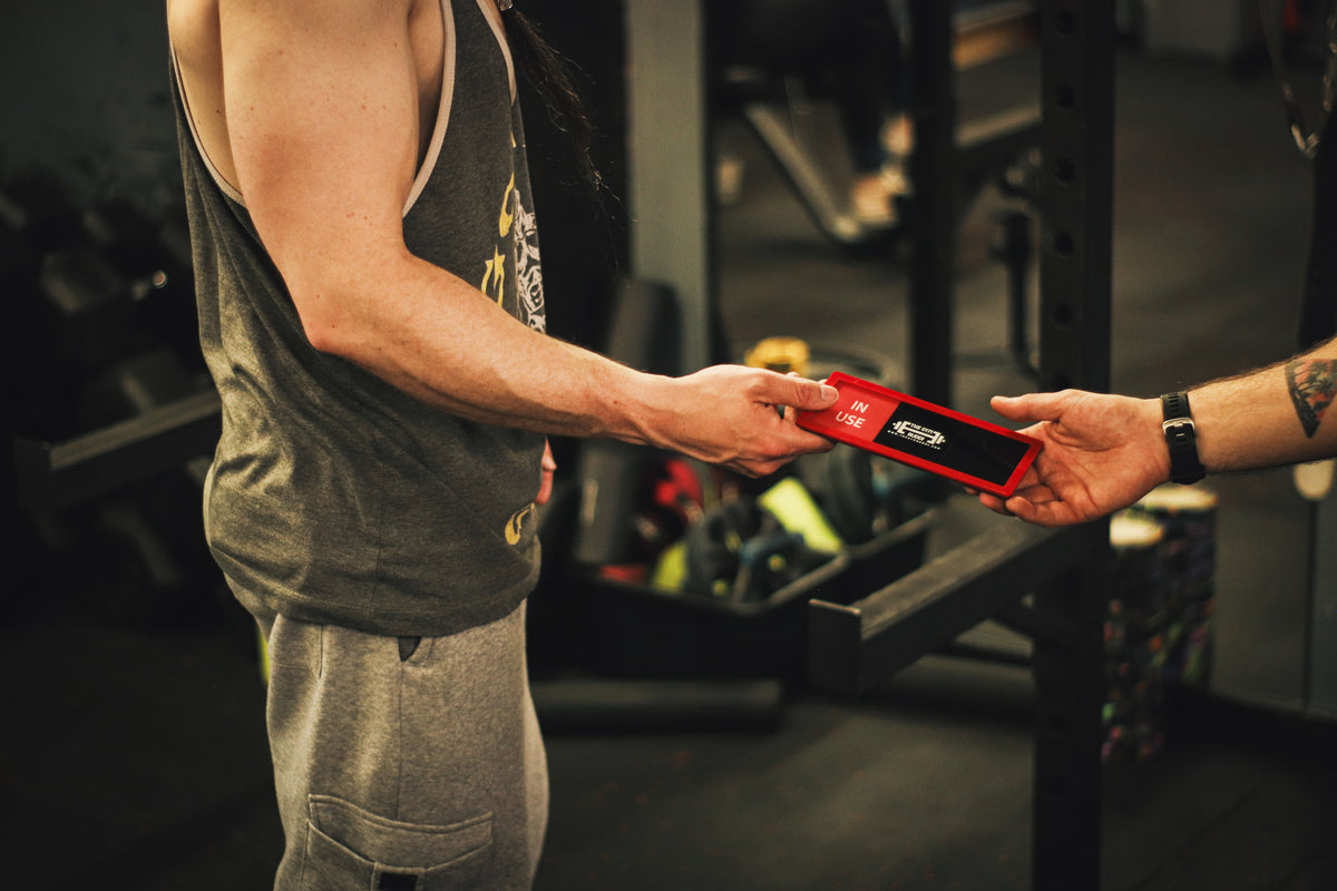 Handing over a Gym Buddi in the gym